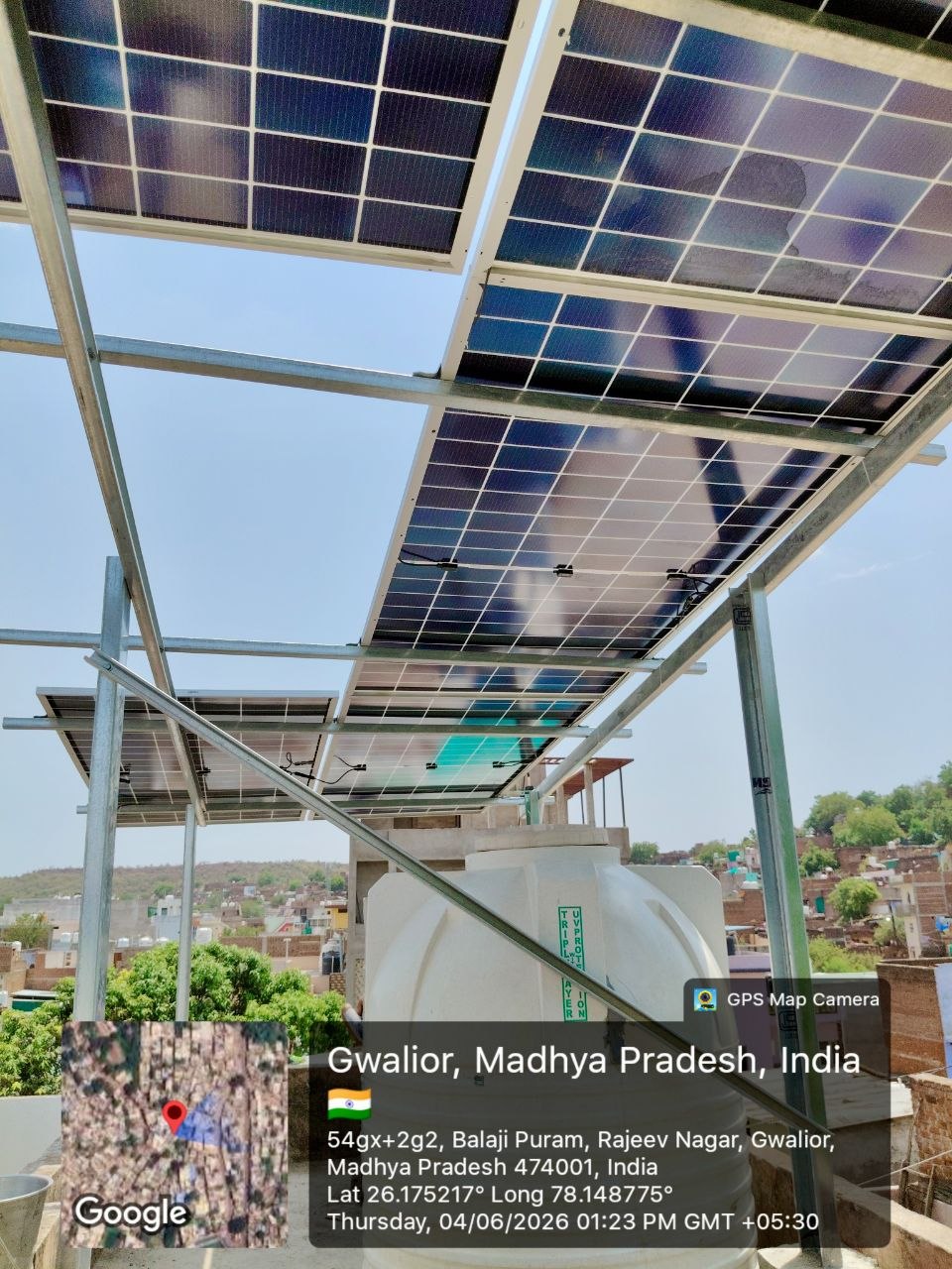 Solar panels above water tank on residential rooftop